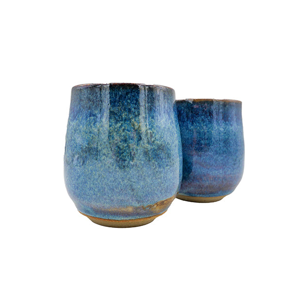 Side photo of side-by-side pair of stoneware wine mugs with blue glaze handmade by Allison Morrissey