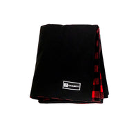 Front view of Denim Blanket Company black denim blanket with red buffalo check fleece lining