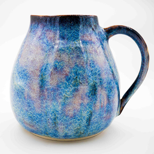 Side photo of stoneware pitcher with periwinkle glaze handmade by Allison Morrissey