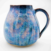 Side photo of stoneware pitcher with periwinkle glaze handmade by Allison Morrissey