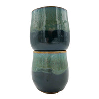 Side photo of stacked pair of stoneware wine mugs with teal glaze handmade by Allison Morrissey