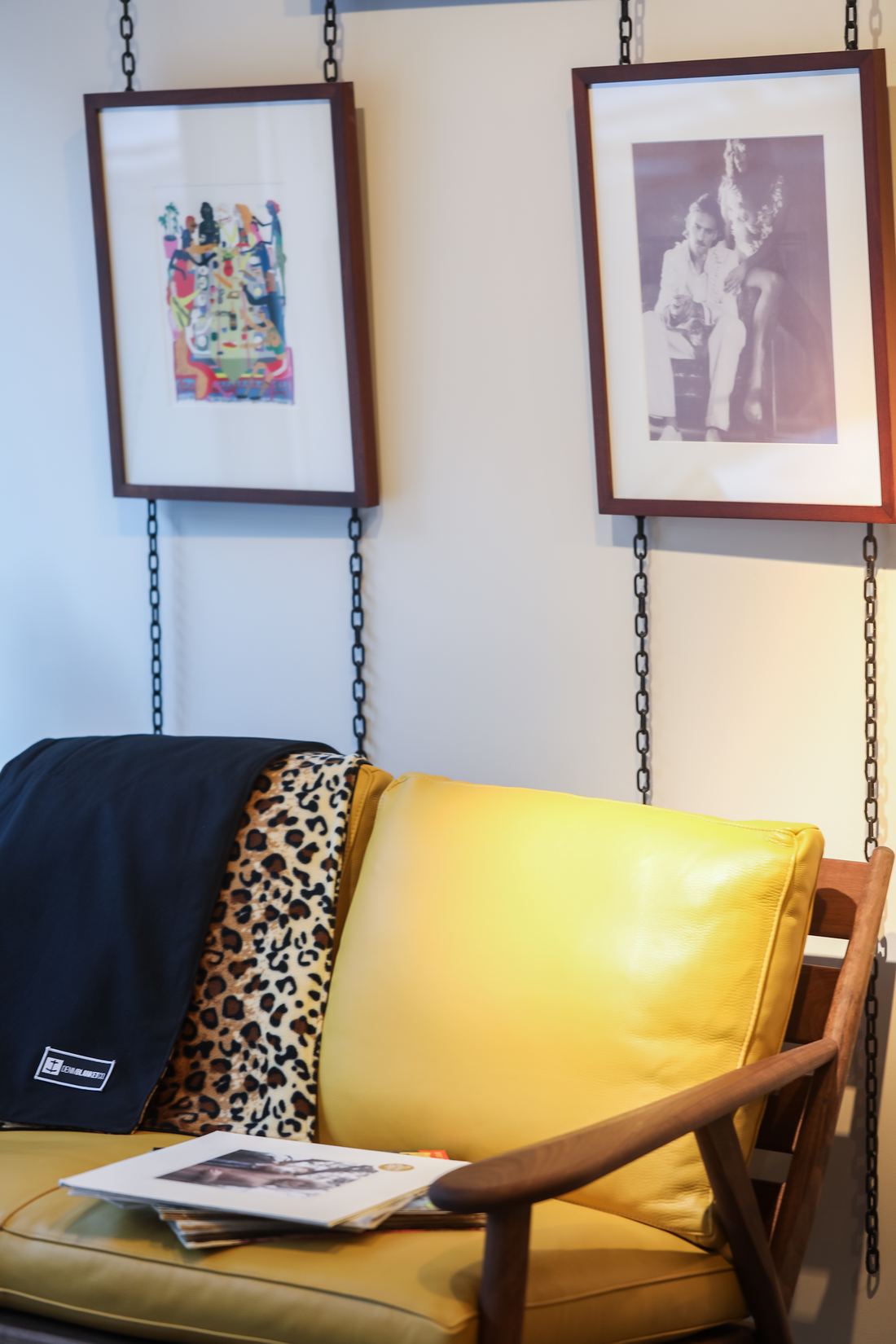 Denim Blanket Company black denim blanket with leopard print fleece lining styled on yellow sofa