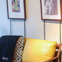 Denim Blanket Company black denim blanket with leopard print fleece lining styled on yellow sofa