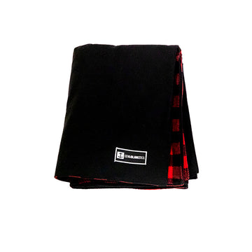 Front view of Denim Blanket Company black denim blanket with red buffalo check fleece lining