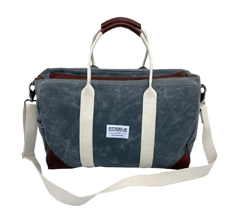 Front view of Steele Canvas slate colored canvas duffle gym travel bag with brown leather accents