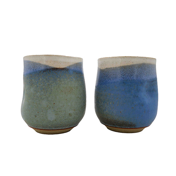 Side photo of side-by-side pair of  stoneware wine mugs with blue, green, and cream glaze handmade by Allison Morrissey