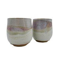 Side-by-side pair of stoneware wine mugs with pink and cream glaze handmade by Allison Morrissey