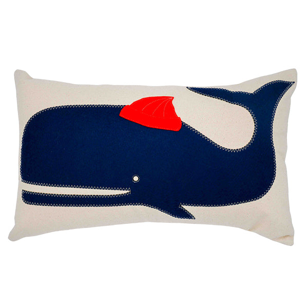 Salty Cottage cream lumbar throw pillow with navy whale wearing a red cap