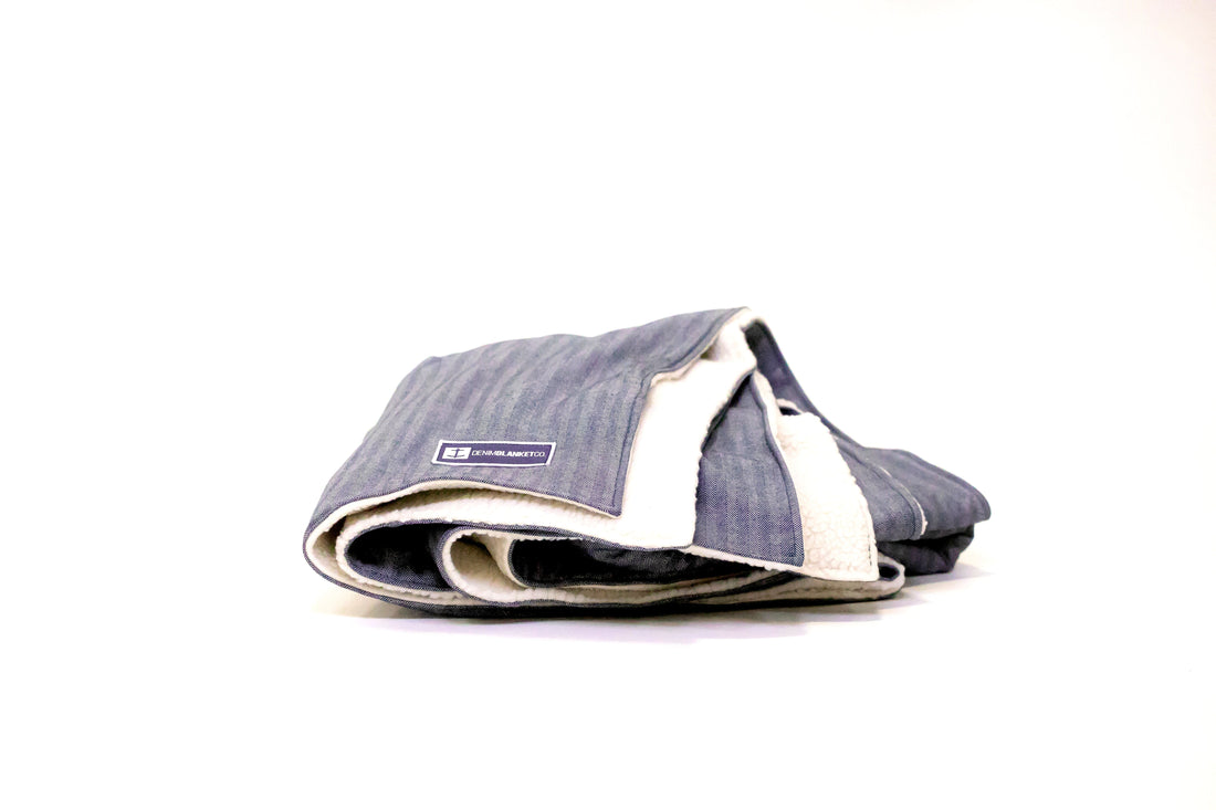 Side view Denim Blanket Company herringbone denim blanket with cream fleece lining