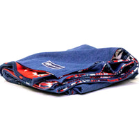 Side view of Denim Blanket Company classic jean denim blanket with southwestern print fleece lining